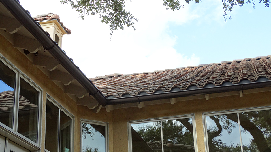 spanish tiled roof with brown gutters